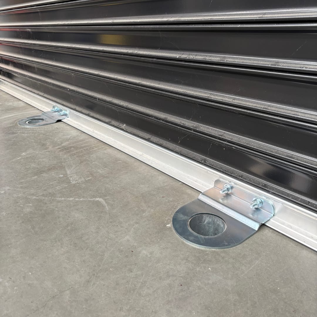 Roller door lockdown plate installed at floor level to prevent ram raid vehicle entry